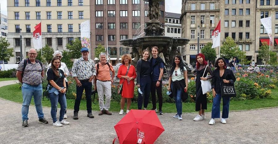 Explore Düsseldorf with Passionate tour guides! - Starting under the red umbrella at Leonidas